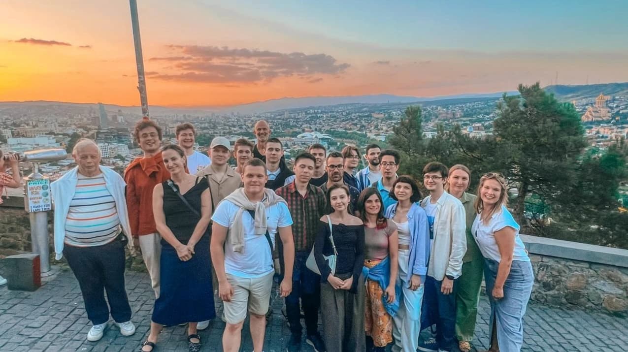 The Imby team together outdoors overlooking the city at sunset.